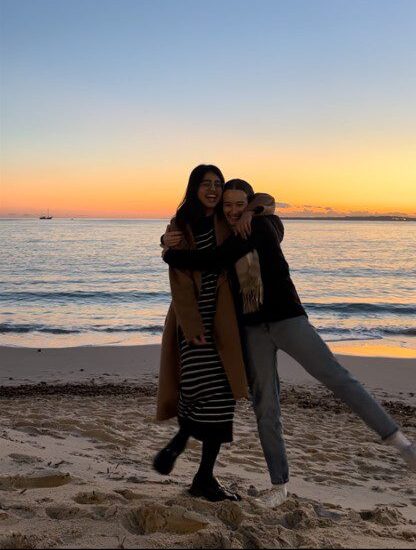 Alviya Siddiqui with friend on a beach at sunset