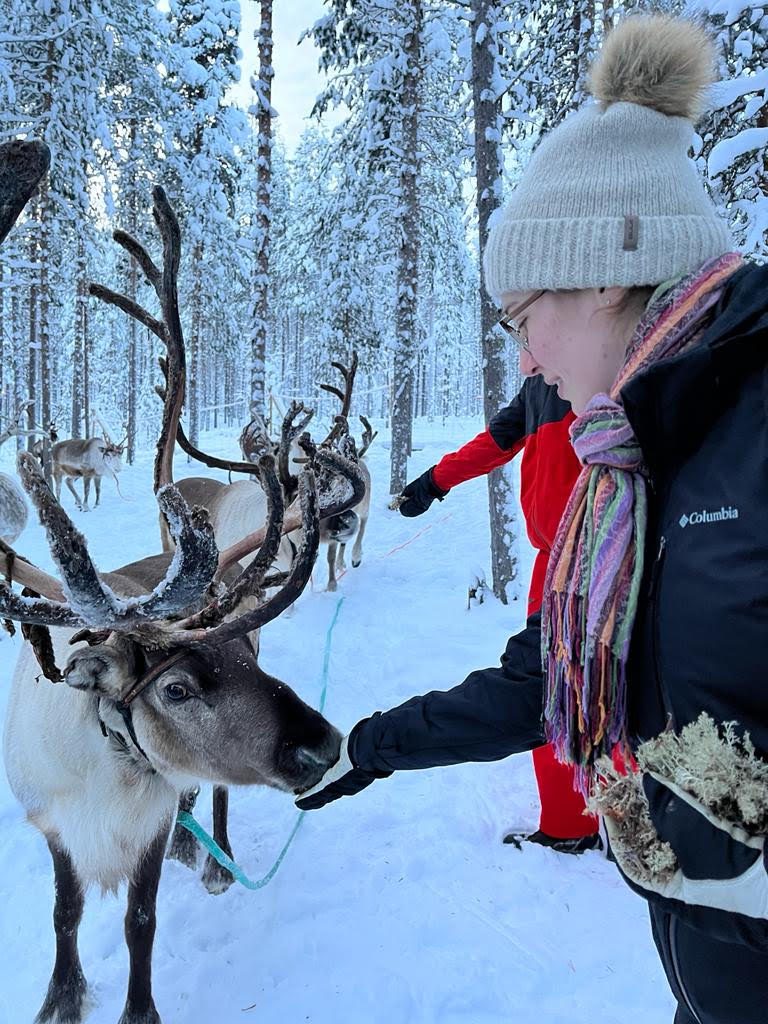 Alexandra Myszkowski feeding a reindeer in Sweden