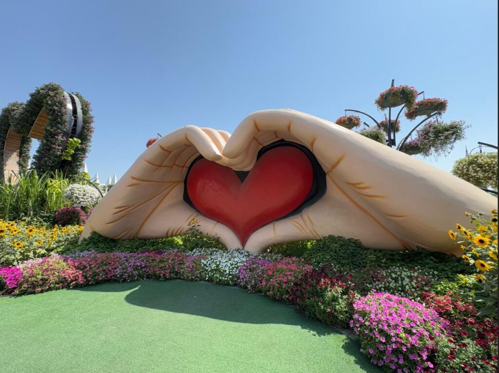 Giant hands holding heart in colouful Dubai Miracle Garden