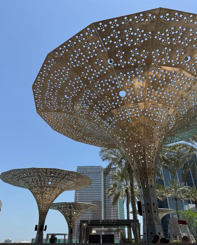 Metal palm tress with real palm trees outside Rosewood Hotel