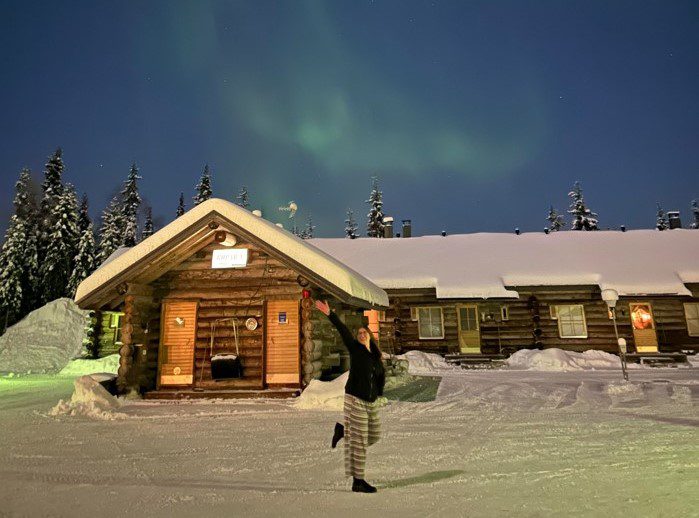 Alexandra Myszkowski in Sweden with Northern lights in the background